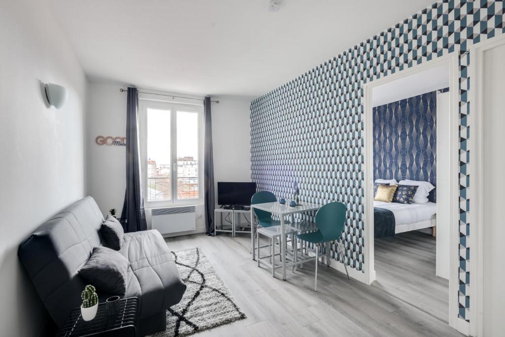 a living room with a couch and a bedroom at 806 Suite Magic - Superb Apartment in Bagnolet