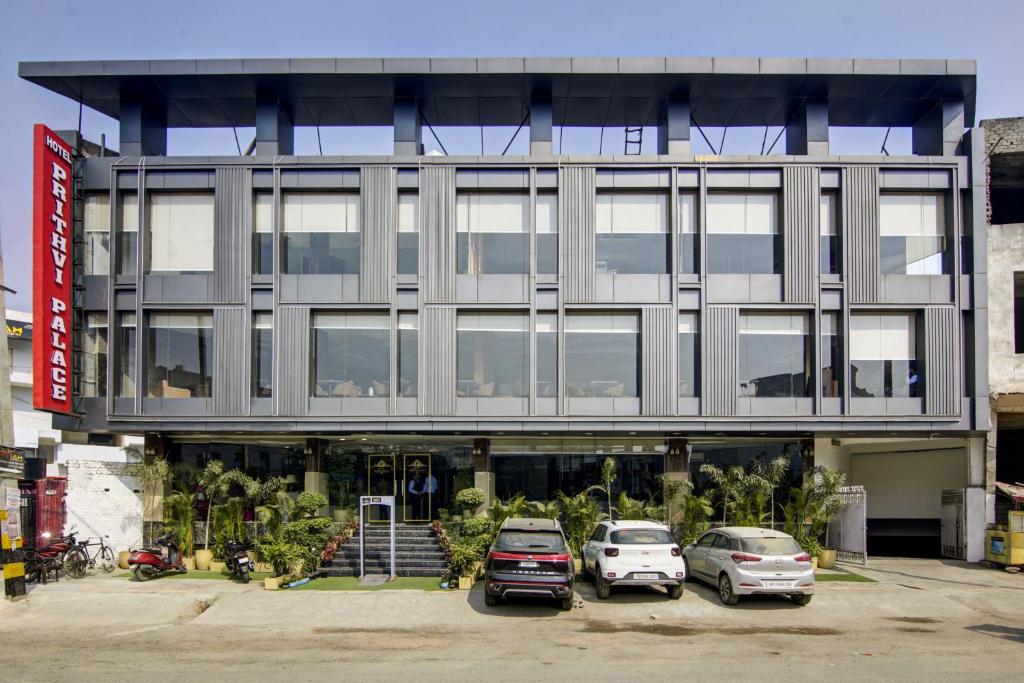 two cars parked in a parking lot in front of a building at Hotel Park Tree - IGI Airport A UNIT Of PRITHVI PALACE in New Delhi