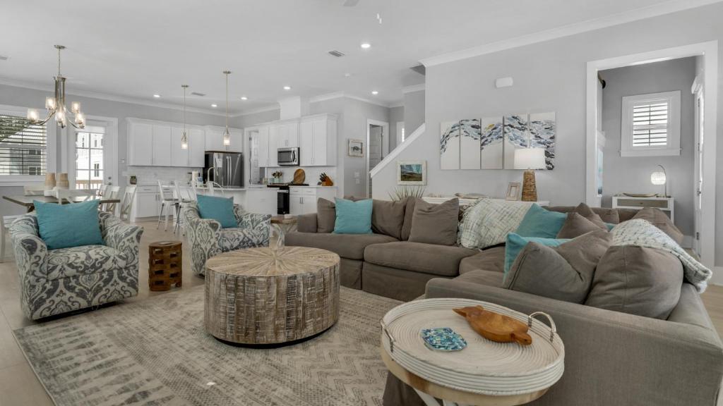 a living room with a couch and a table at Sitting Bayside in Santa Rosa Beach
