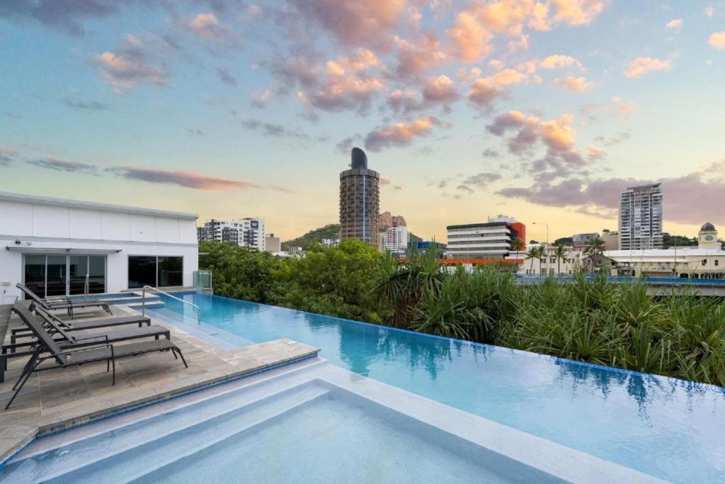 a large swimming pool with a view of the city at Apartment on Palmer in Townsville