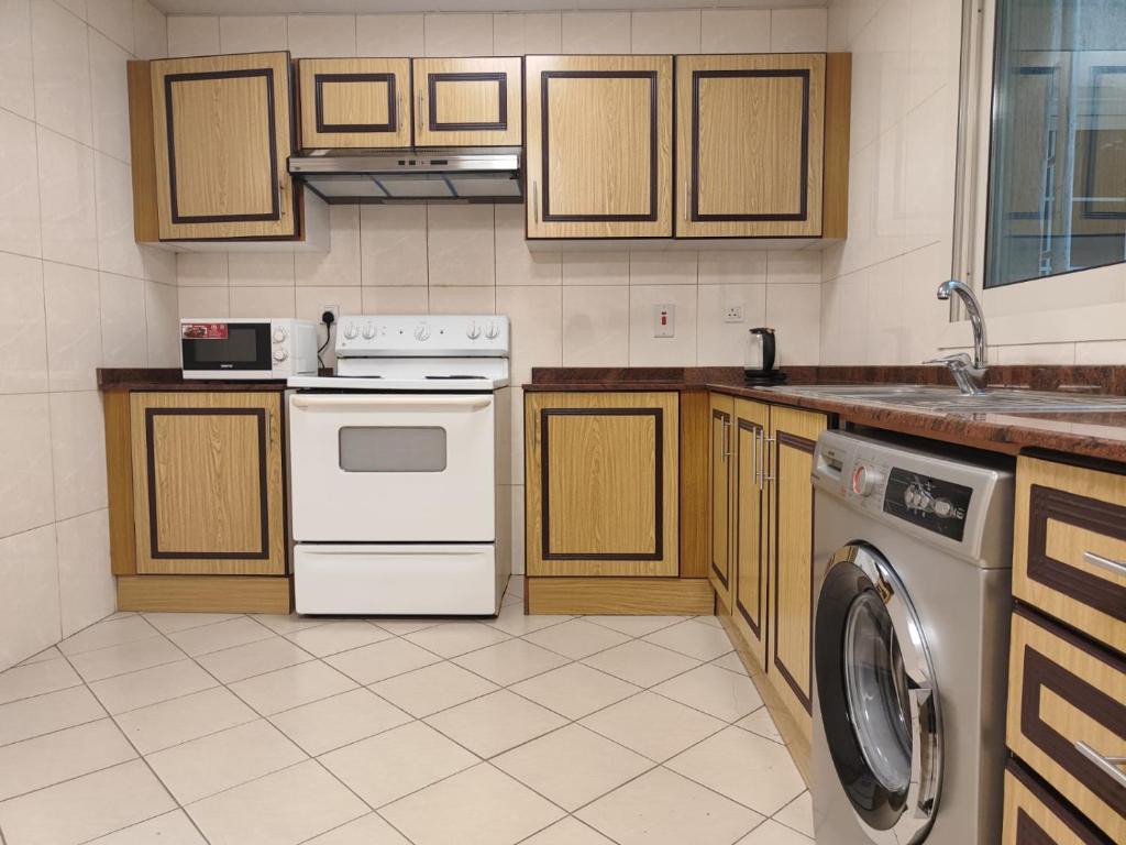 a kitchen with a washer and a dishwasher at Al Raya Hotel Apartments in Dubai