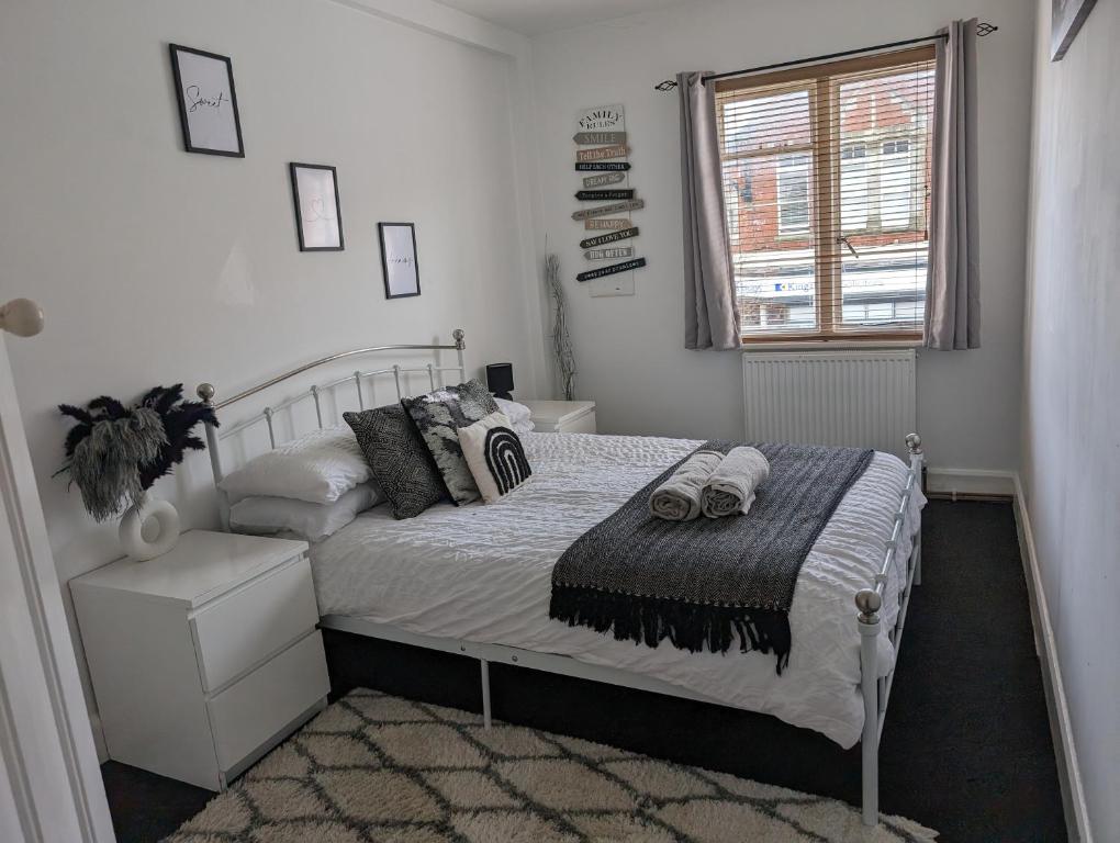 a bedroom with a bed and a window at Twenty Four in Hythe