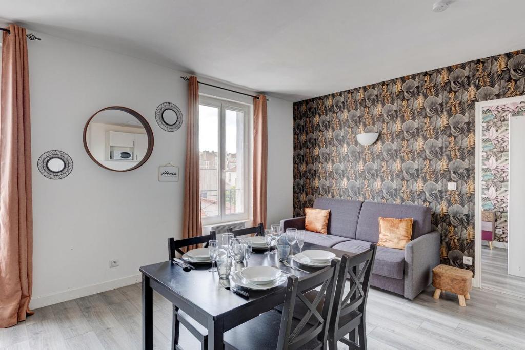 a dining room with a table and a couch at 809 Suite Fantastic - Superb apartment in Bagnolet