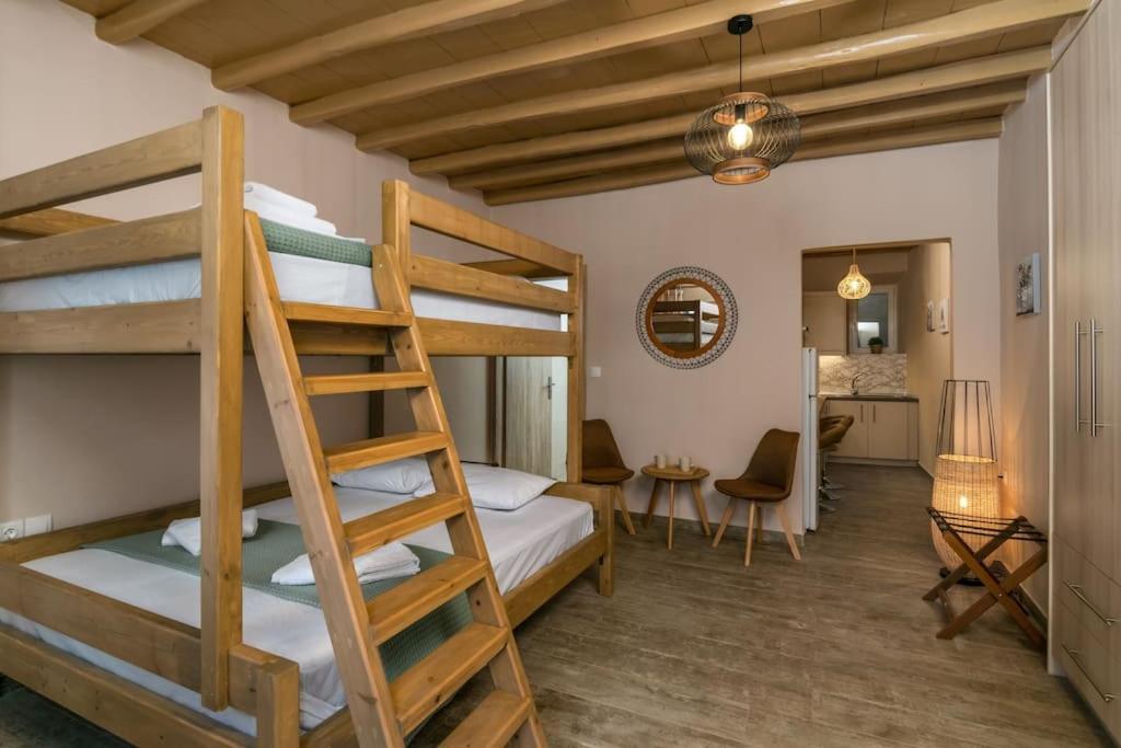 a bedroom with two bunk beds and a living room at Casa Della Zia in Plaka Milou