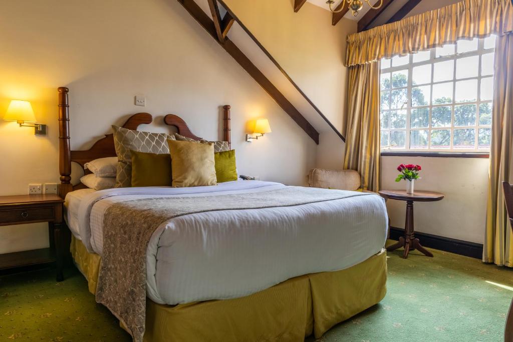 Postel nebo postele na pokoji v ubytování Midland Hotel Nakuru