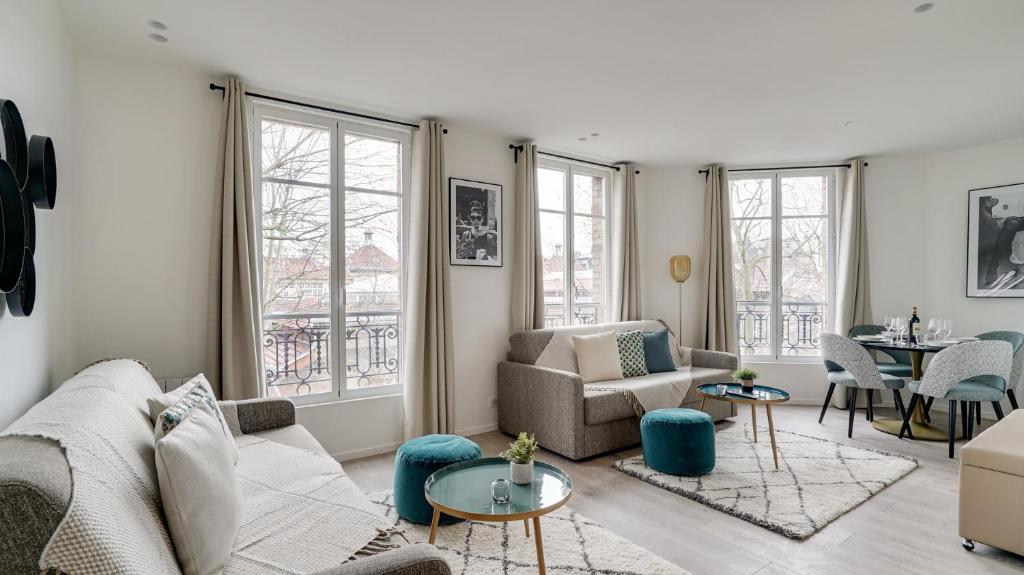 a living room with a couch and a table at 153 Suite Mylene - Superb apartment in Paris in Paris