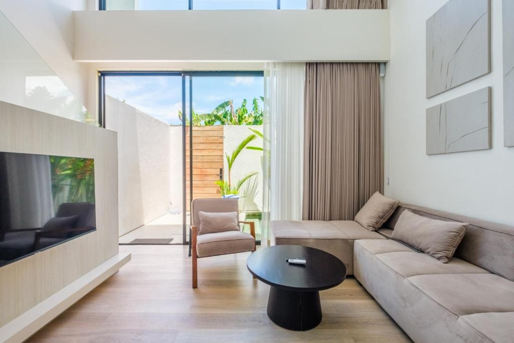 a living room with a couch and a table at Oasis Smart Villa 3 in Canggu