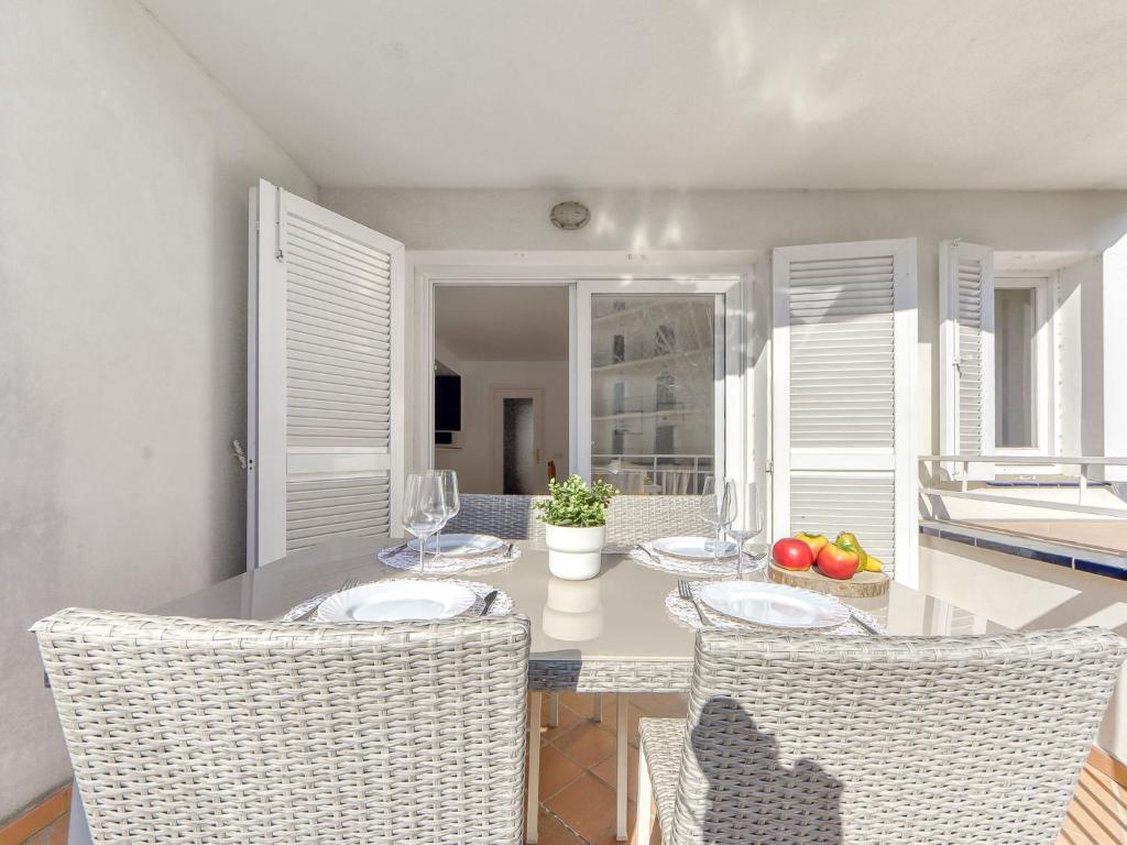 a dining room with a table and chairs at Apartment Platja de Roses-10 by Interhome in Roses