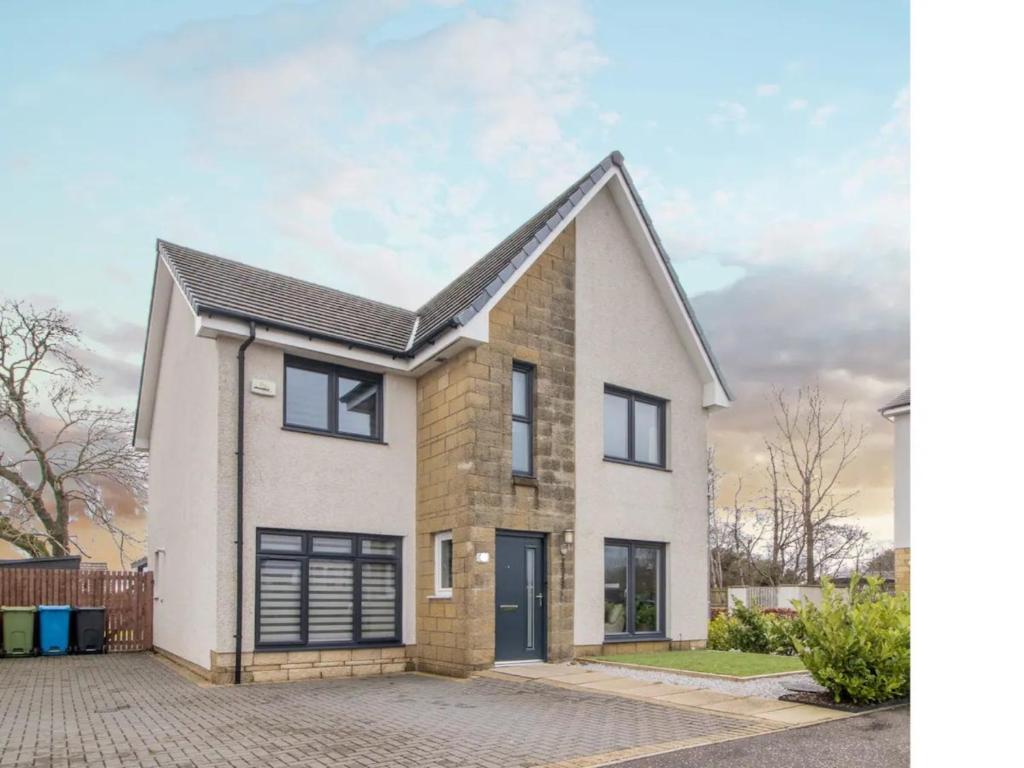 an image of a house with a garage at Pass the Keys Comfortable and Fabulous Family Home in Newton Mearns