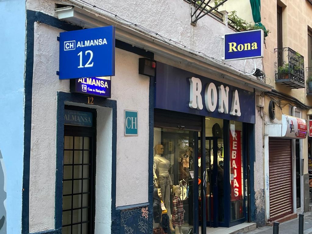 a row of store fronts on a city street at Casa de Huéspedes Almansa in Madrid