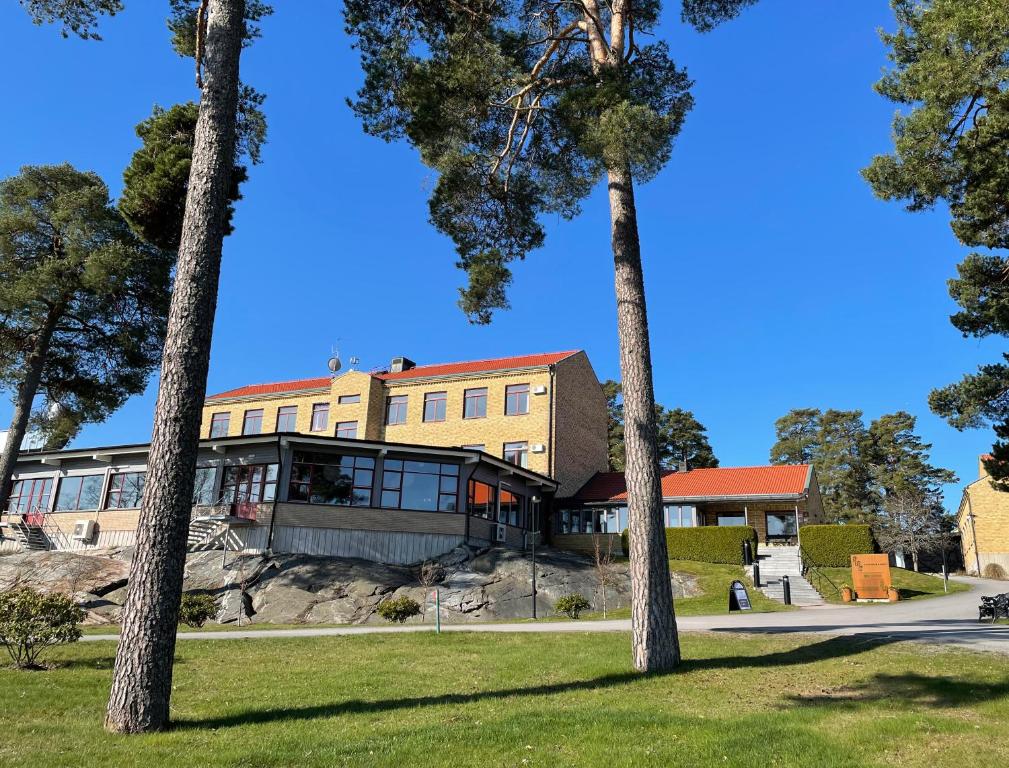 a building with palm trees in the foreground at Runö Möten & Events in Åkersberga