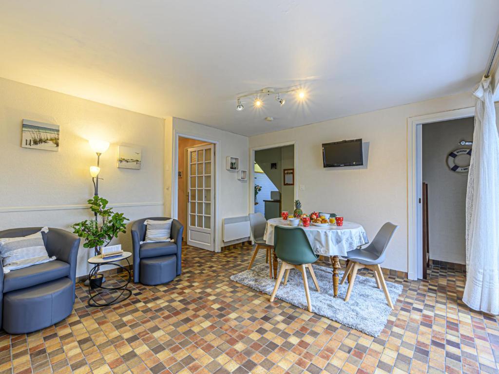 a living room with a table and chairs at Apartment Les Embruns-1 by Interhome in Carnac