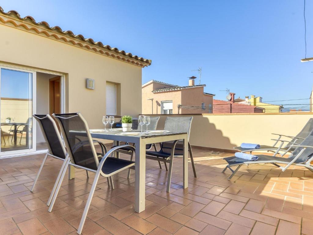 a dining table and chairs on a patio at Apartment Puigmal by Interhome in Empuriabrava