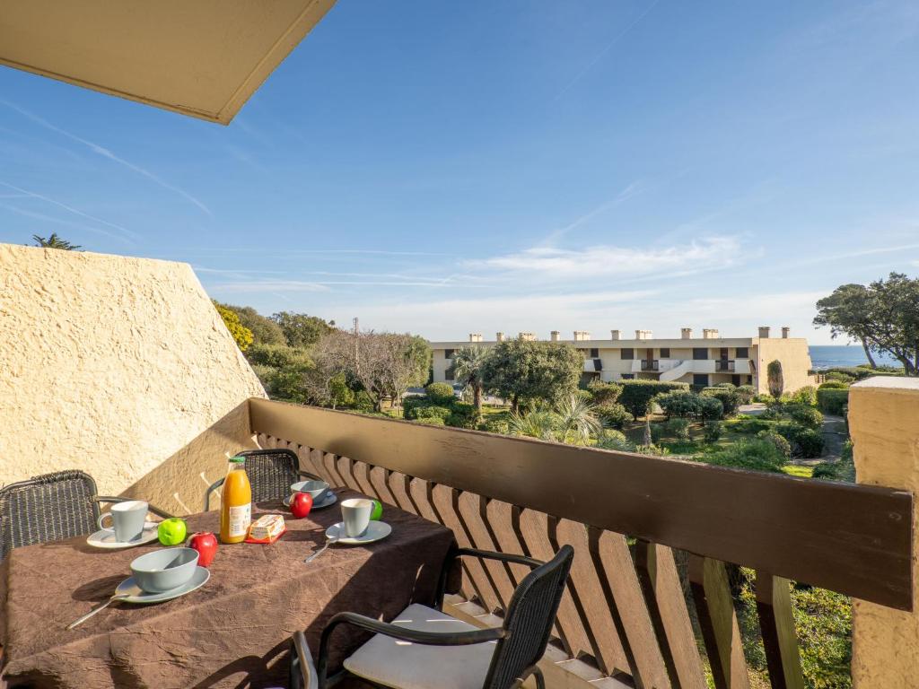 a table and chairs on a balcony with a view at Apartment Les Louvans-4 by Interhome in Saint-Aygulf