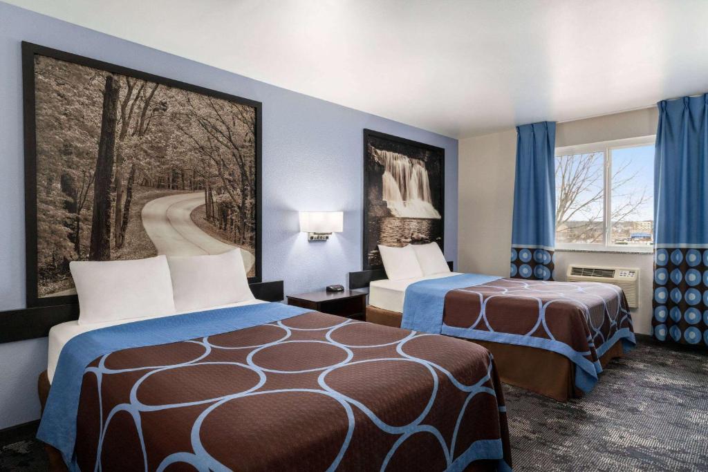 a hotel room with two beds and a window at Super 8 by Wyndham Columbus Edinburgh in Columbus