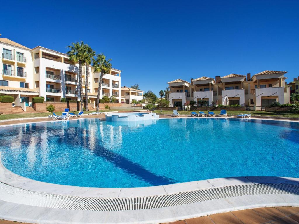 a large swimming pool in front of some apartment buildings at Apartment Vilas Mouriscas by Interhome in Vilamoura