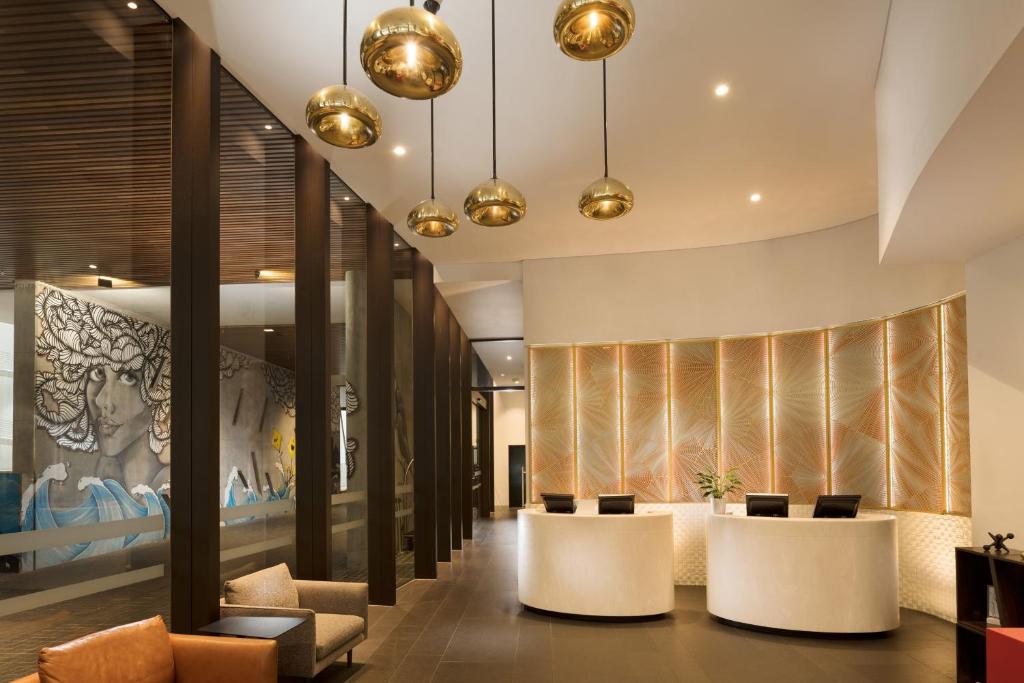 a lobby with a row of tables and chairs at Four Points by Sheraton Brisbane in Brisbane