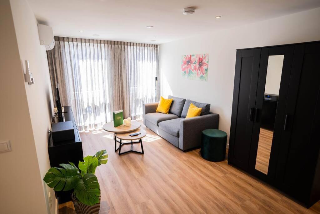a living room with a couch and a table at Fancy 70m2 Apartment with Terrace - WE39F in Tiel