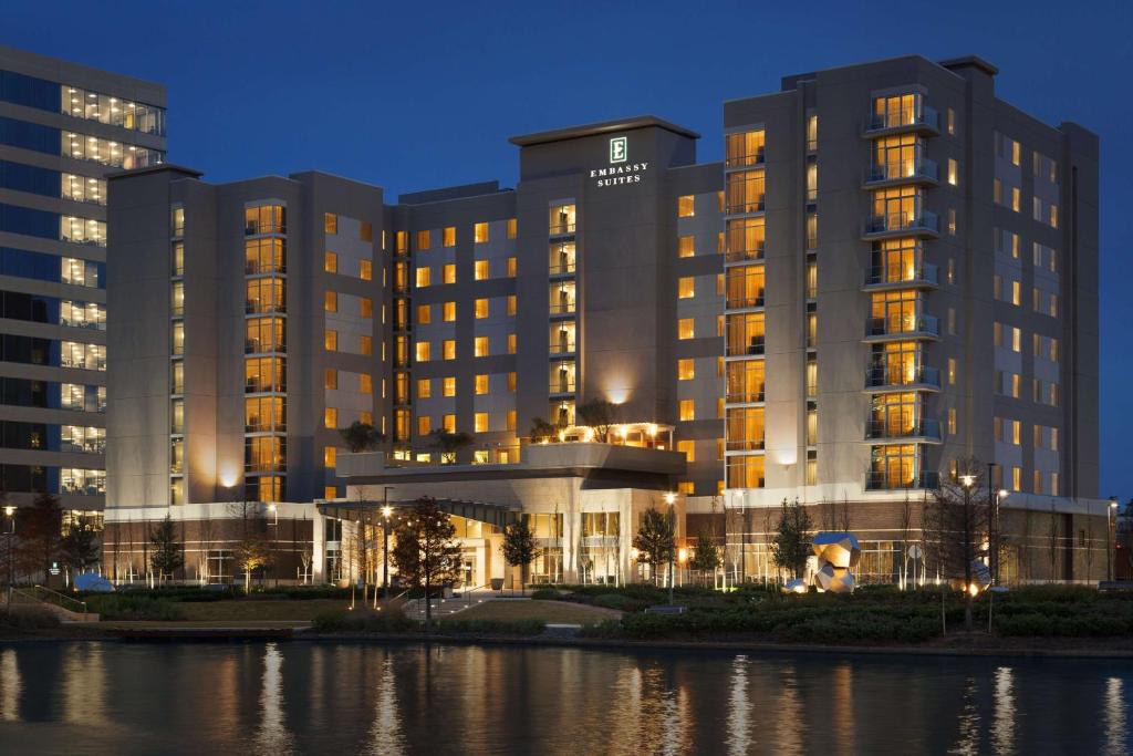 a rendering of a hotel at night at Embassy Suites by Hilton The Woodlands in The Woodlands