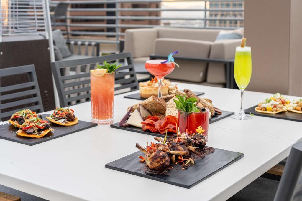 a table with four plates of food and drinks at Hilton Garden Inn Phoenix Downtown in Phoenix