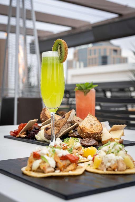 a table with two plates of food and a drink at Hilton Garden Inn Phoenix Downtown in Phoenix