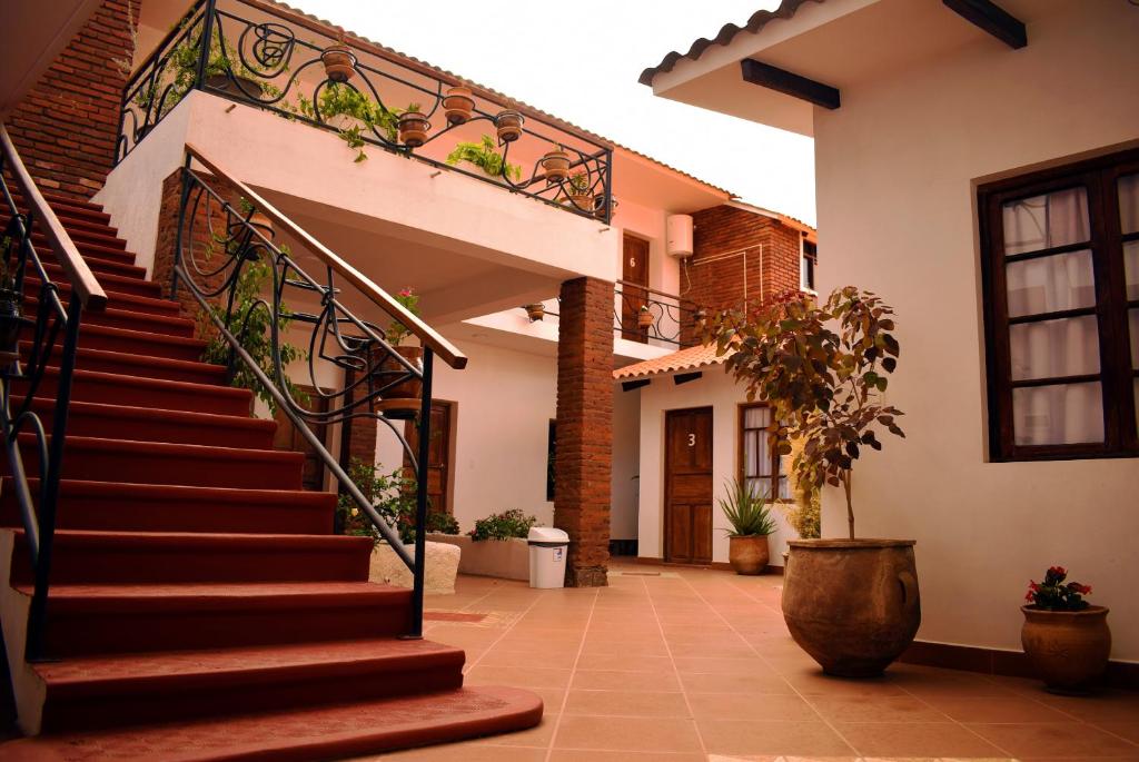 a house with a staircase in a courtyard at Casa San Martin Suites in Cochabamba