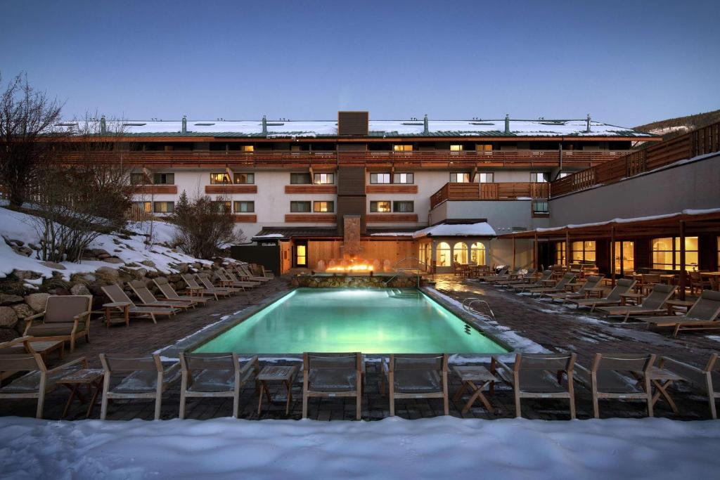 a pool in front of a hotel in the snow at Highline Vail - a DoubleTree by Hilton in Vail