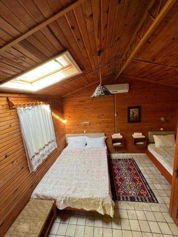 a bedroom with a bed in a wooden room at Myland Nature in Cıralı