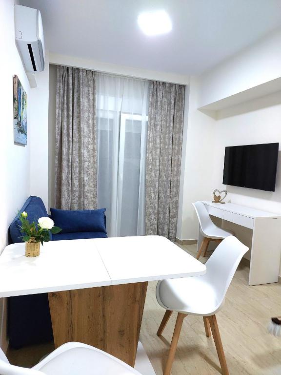 a living room with a white table and chairs at Navarino Luxe Suites in Perea