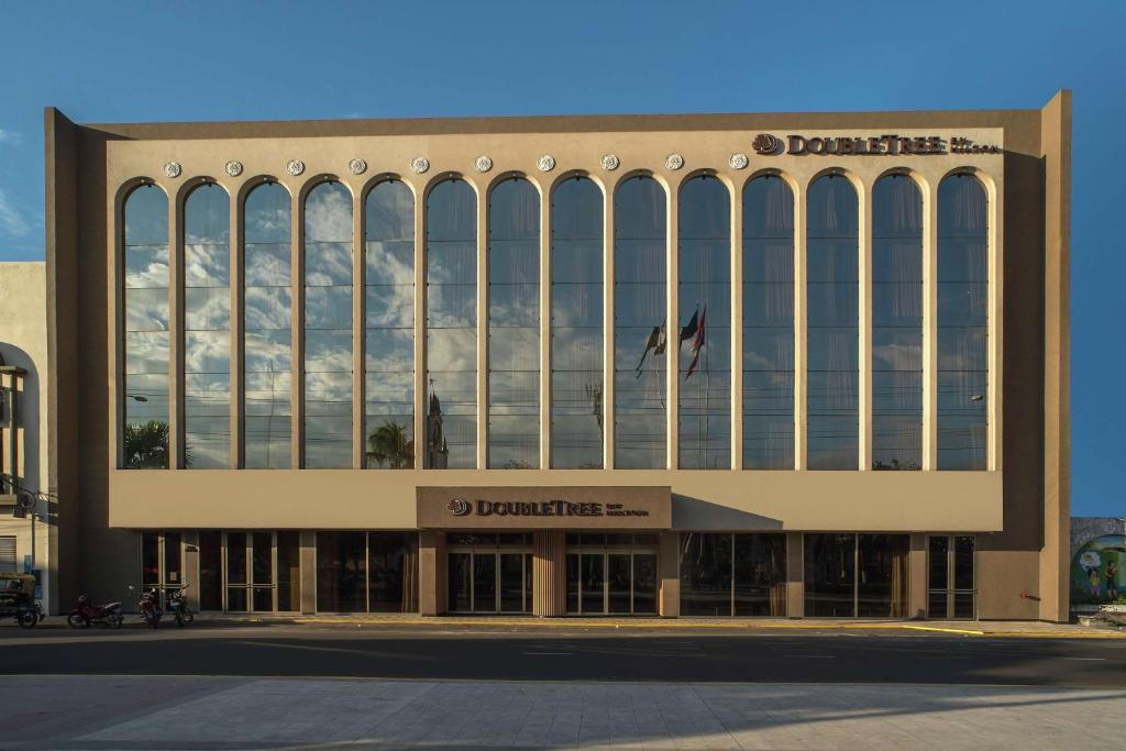 a large building with a lot of windows at Doubletree By Hilton Iquitos in Iquitos