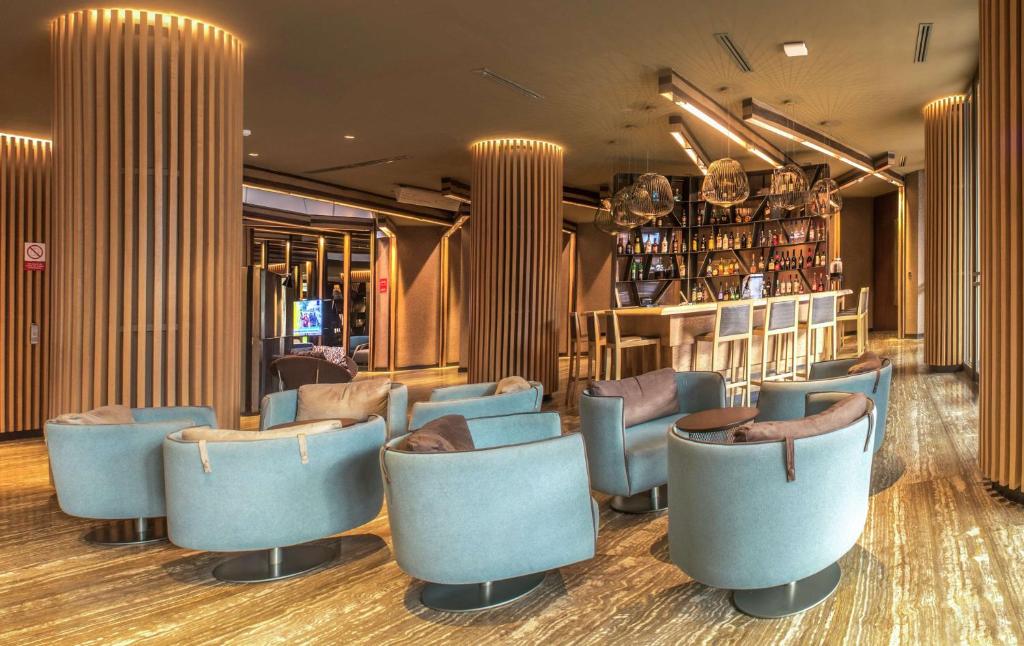 a restaurant with blue chairs and a bar at Doubletree By Hilton Iquitos in Iquitos