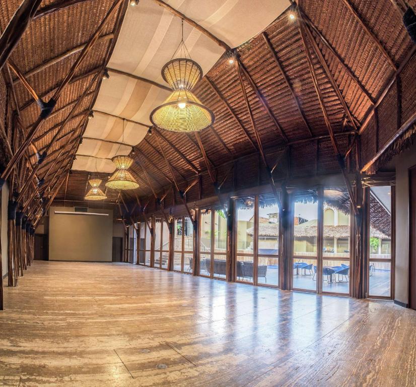 a large room with a wooden floor and large windows at Doubletree By Hilton Iquitos in Iquitos
