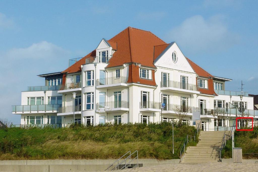 a large white building with a red roof at Schloss am Meer 9 in Wyk auf Föhr