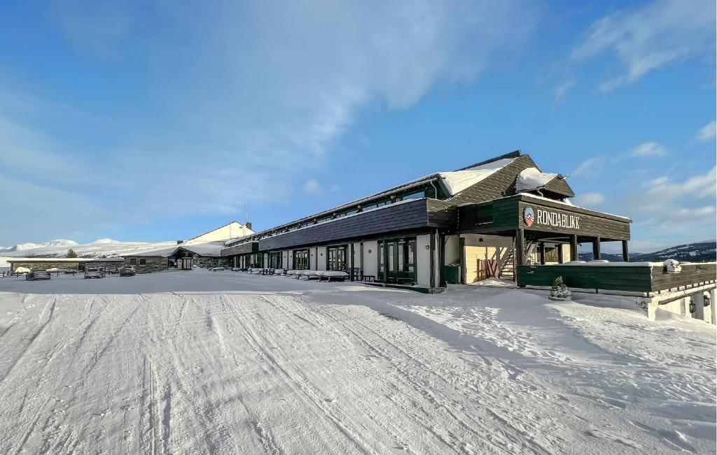 a building in the snow with a snow covered ground at Nice Apartment In Kvam With Sauna in Kvam