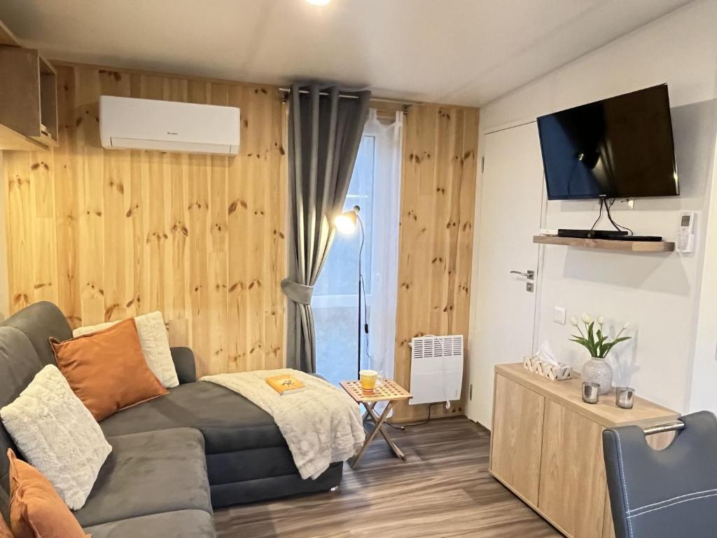 een kleine woonkamer met een bank en een tv bij Holiday Home Eule by Interhome in Wemding