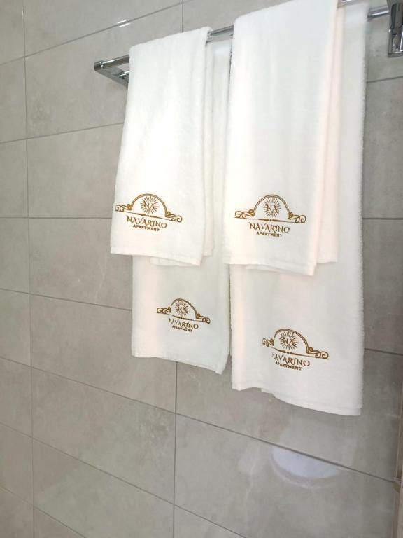 a group of towels are hanging in a bathroom at Navarino Luxe Suites in Perea