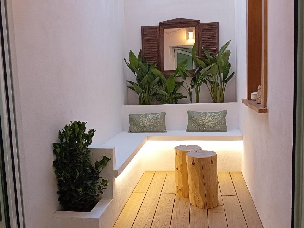 a hallway with a mirror and two potted plants at El rinconet in Partida de La Cañada