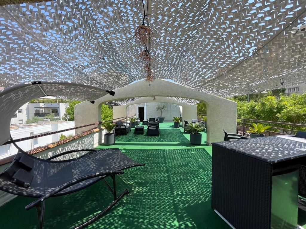 a building with a green floor and a ceiling with lights at Hôtel Ulysse Montpellier Centre in Montpellier