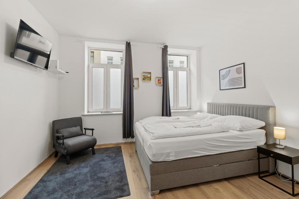 - une chambre avec un lit et une chaise dans l'établissement StayEasy Apartments Vienna A#3, à Vienne