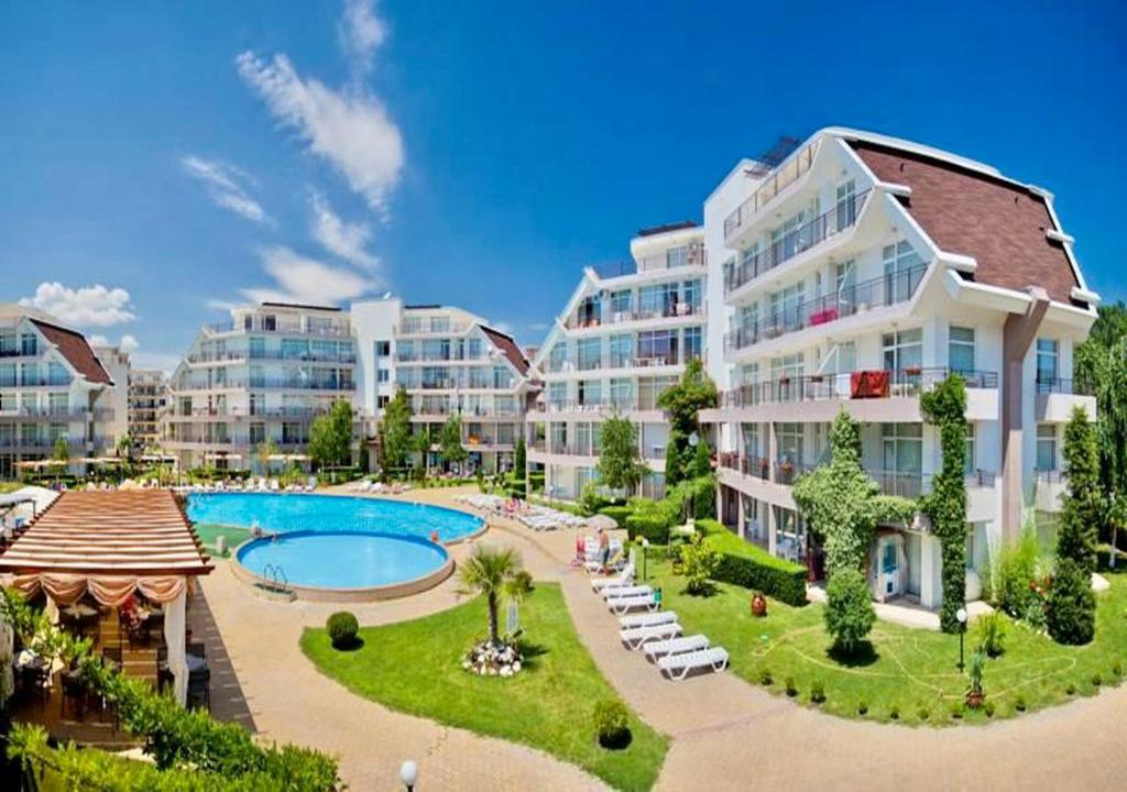 an apartment complex with a pool and a resort at Charming 2-bed flat with pool view in Sunny Beach, Bulgaria in Sunny Beach