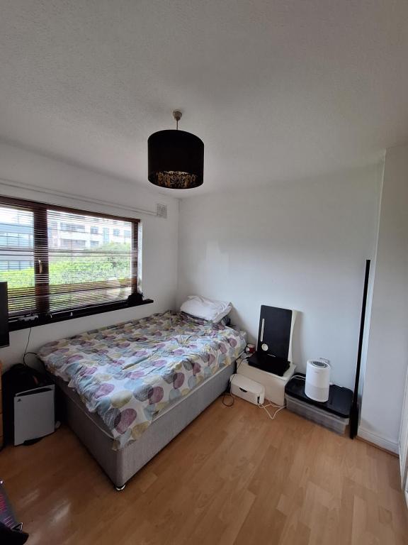 a bedroom with a bed and a large window at Spacious double bedroom in quiet house with garden view in Dublin