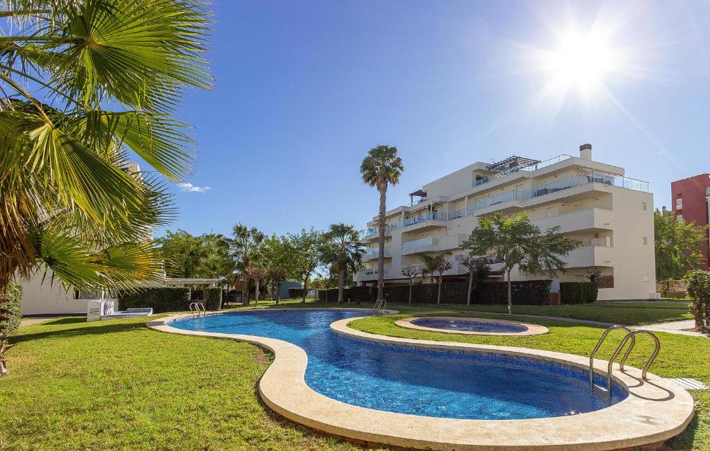 a swimming pool in front of a building at Beautiful Apartment In El Vergel in Denia