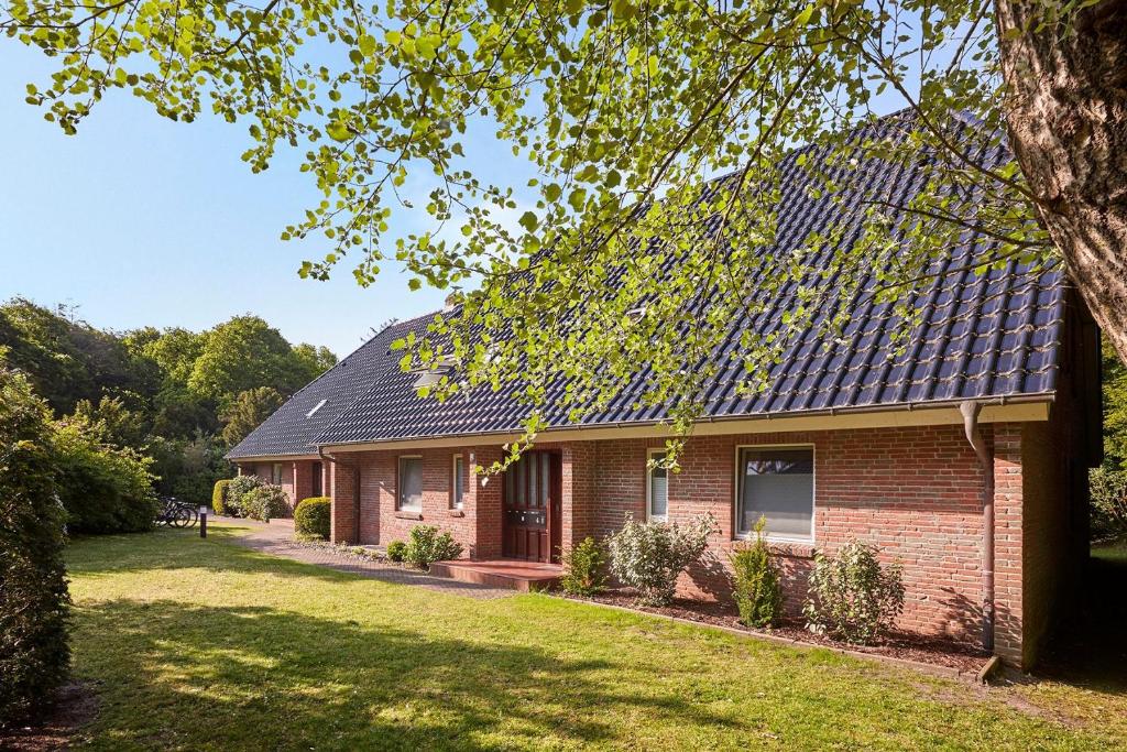 una casa in mattoni rossi con tetto solare di Wohnen am Südstrand 03 a Wyk auf Föhr