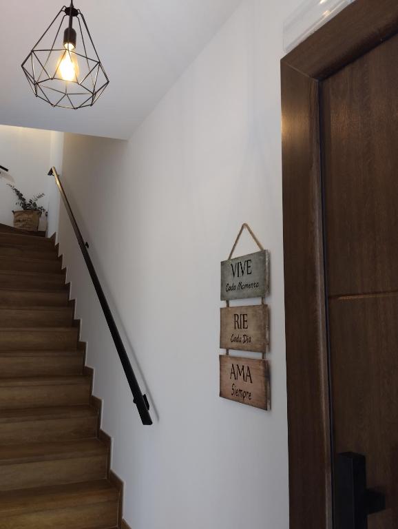 a staircase with a sign that says wine life amana at CASA RURAL U FORTI in Valverde del Fresno