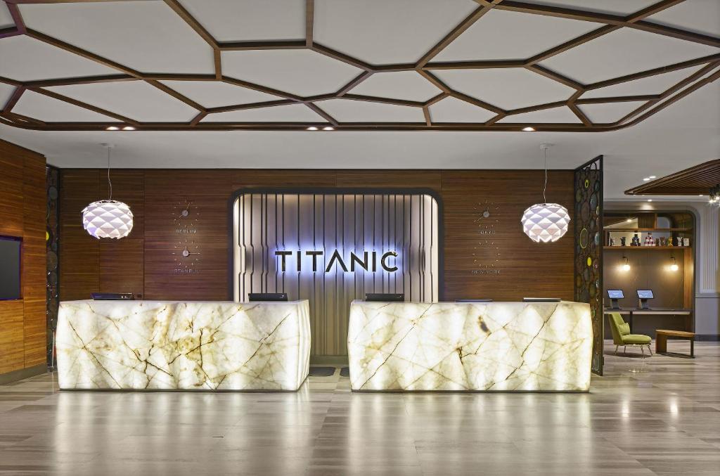 a lobby with two reception desks in a building at TITANIC Chaussee Berlin in Berlin