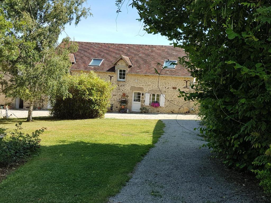 ein großes Backsteinhaus mit einem Rasenhof in der Unterkunft Gîte Arçonnay, 6 pièces, 14 personnes - FR-1-410-300 in Arçonnay