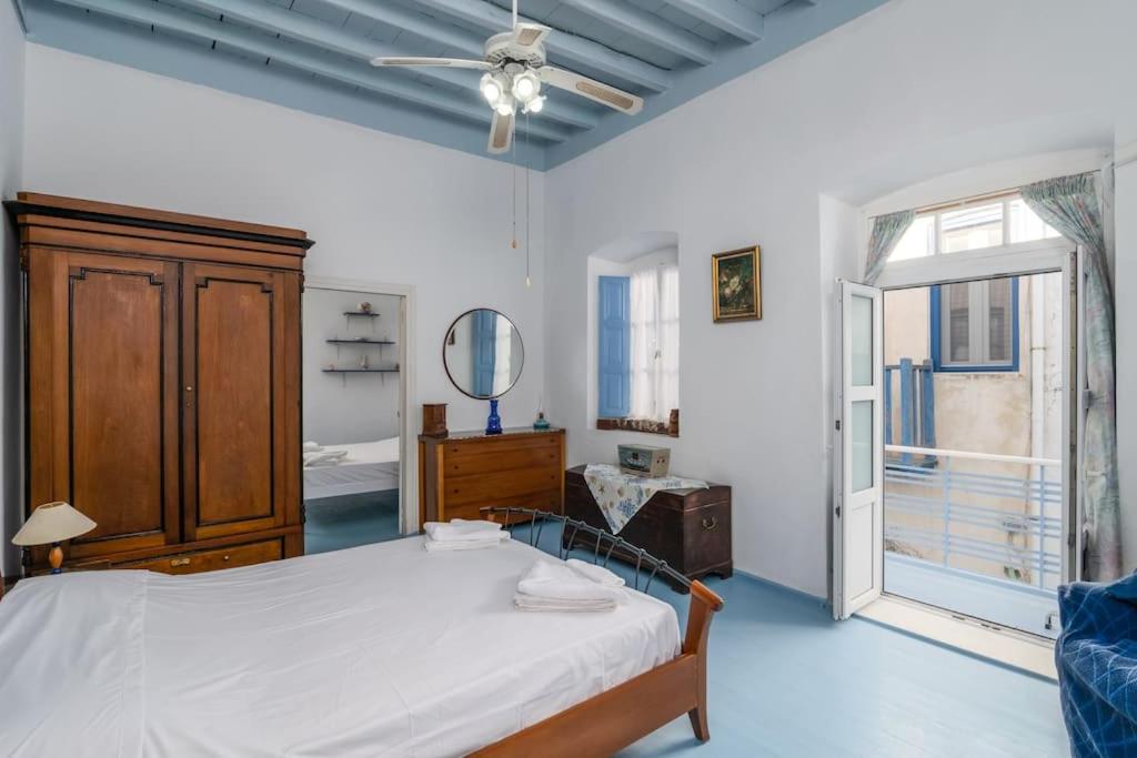 a bedroom with a bed and a large window at Rustic House in Plaka in Plaka Milou