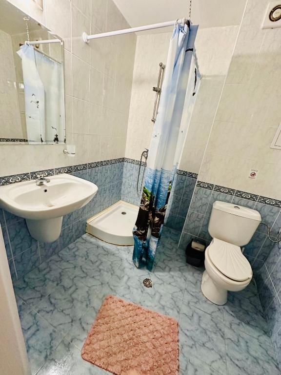 a bathroom with a toilet a sink and a shower at Charming 2-bed flat with pool view in Sunny Beach, Bulgaria in Sunny Beach