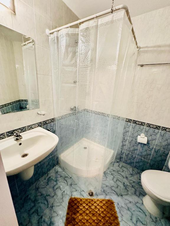 a bathroom with a sink and a toilet and a shower at Charming 2-bed flat with pool view in Sunny Beach, Bulgaria in Sunny Beach