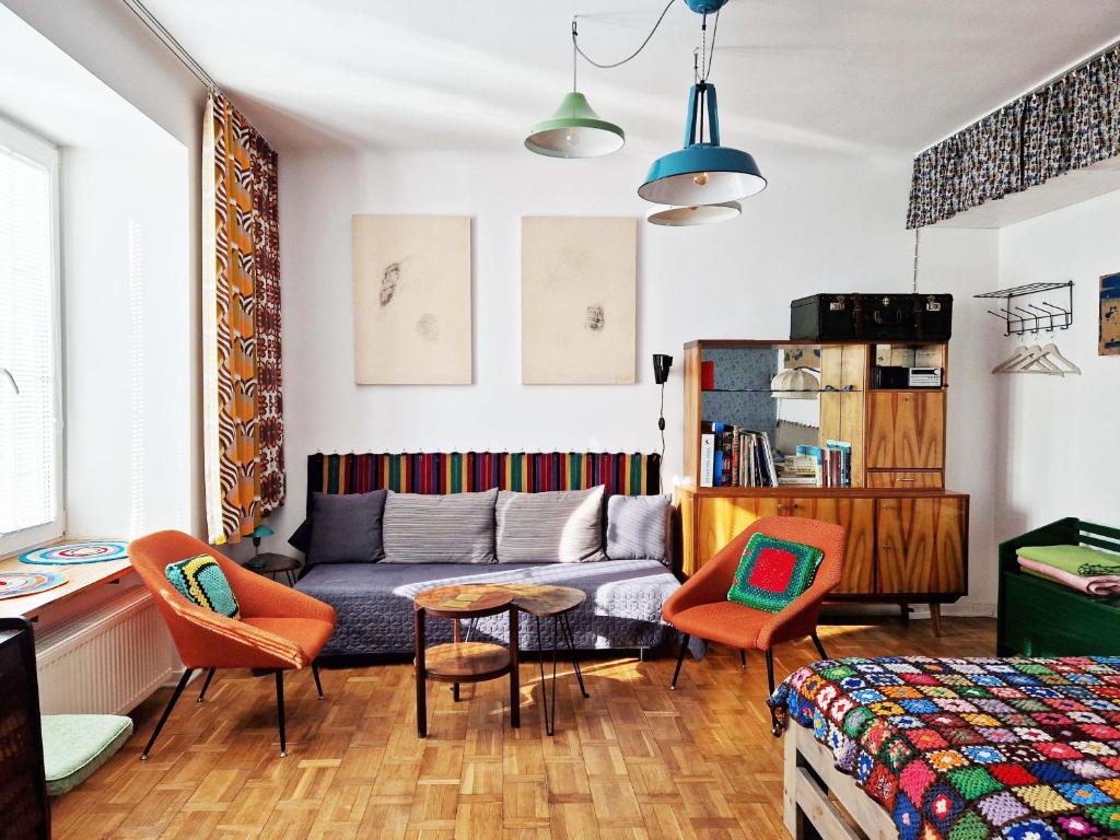 a living room with a couch and chairs and a table at STUDIO KLIMAT PRAGA in Warsaw
